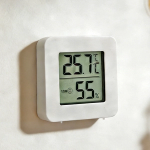 Mini indoor digital thermometer and hygrometer with LCD display showing 25.7C and 55%