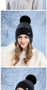 Detail of winter knit hat featuring large faux fur pom-pom and thick ear protection