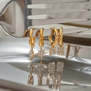 Golden stainless steel hoop earrings with sparkling crystal star and bear pendants