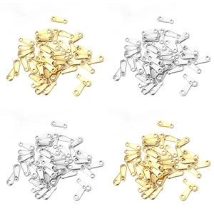 Macro shot of gold and silver heart and star stainless steel connector tags for jewelry DIY