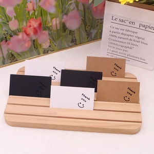 Three-color earring display cards with thank you smile on tiered wooden stand