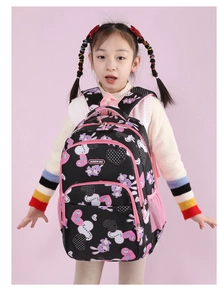 Girl model showing a black ergonomic school bag with pink rabbit and heart patterns