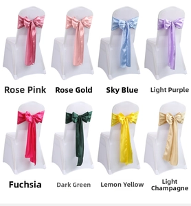 Detail view of colorful satin chair sashes in rose pink, gold, blue, and purple tones