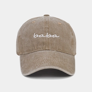 Detail of white baba embroidery on washed khaki twill cotton vintage baseball cap