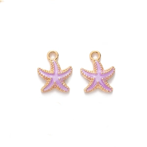 Close-up of purple enamel starfish charms with gold edges on white background