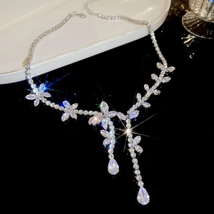 Detail of silver tassel necklace featuring zircon flowers and teardrop crystal pendants