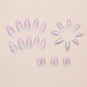 Detail of almond-shaped press-on nails with pink gradient and 3D silver starburst art