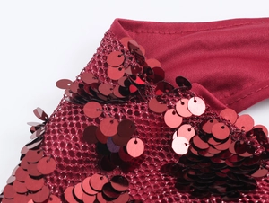 Close-up of red sequin fabric and mesh texture on backless party maxi dress