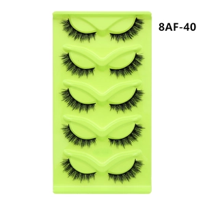 Close-up of 5 pairs of fox-eye cat-eye false eyelashes in model 8AF-40 on a green tray