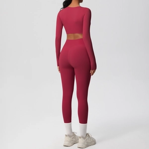 Rear view of deep red long-sleeve crop top and high-waisted yoga set for women