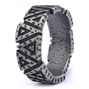 Close-up of wide silver vintage ring with geometric triangle texture on white background