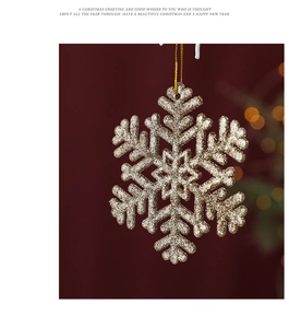 Close-up of golden glitter snowflake Christmas ornament with decorative hanging string
