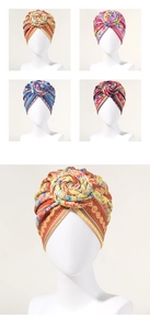 Detail view of colorful bohemian turbans featuring twisted floral rose knot design