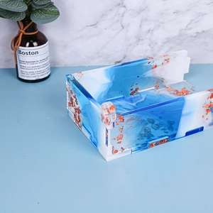 Macro detail of handmade resin storage box with blue marbling and gold leaf gold foil flakes