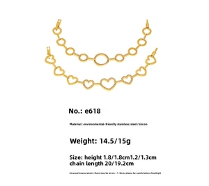 Detailed view of gold plated chain links with hollow hearts and zircon pavé settings