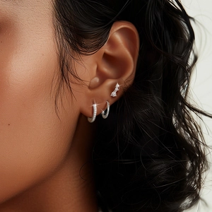 Detail of S925 sterling silver hoop earrings set with zircon micro-pave on ear