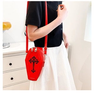 Gothic red coffin shoulder bag with black cross print worn by model with white dress