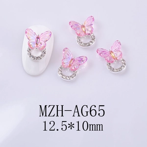 Macro detail of 12.5x10mm pink glass butterfly nail charm with silver diamond ring base