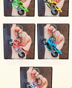 Detailed close-up of motorcycle model keychains in multiple colors with lobster clasps
