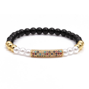 Beaded bracelet with black matte stones, pearls, and gold tube set with colorful zircons