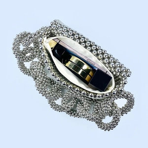 Detail view of silver beaded clutch interior showing storage capacity for phone and makeup