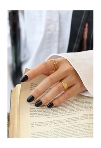 Detail of gold-plated rings with micro-set zircon on vintage background with hands