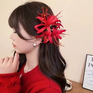 Close-up of red spider lily hair clip with silk petals and realistic floral textures
