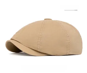 Close-up of beige cotton newsboy cap showing detailed twill fabric and top button