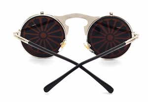 Detail view of steampunk metal flip-up sunglasses with unique wheel pattern round lenses