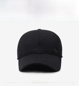 Detailed view of black winter baseball cap with textured fabric and metallic logo detail