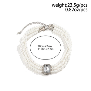 Detail of three-layer pearl choker with a crystal centerpiece and adjustable silver clasp