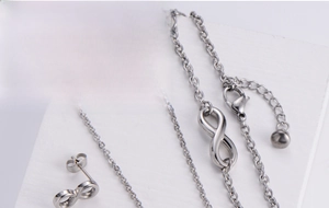 Detail shot of a 4-piece titanium steel jewelry set featuring infinity symbol designs