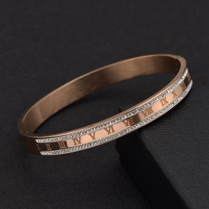 Close-up of rose gold Roman numeral bangle with sparkling pavé crystals and satin finish