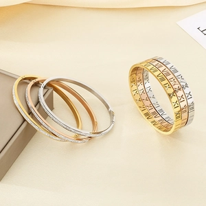 Detailed view of titanium steel bracelets with Roman numerals and pavé crystal setting