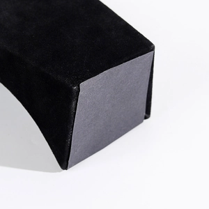 Detailed macro view of black velvet surface texture and base on necklace display stand