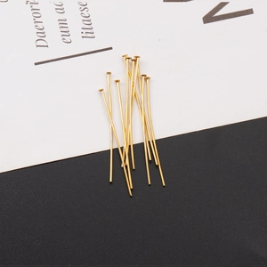 Macro shot of 15-20 gold-plated stainless steel T-pins for DIY jewelry making