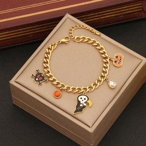 Detail of Halloween charm bracelet with skull, ghost, pumpkin, and crystal pendants