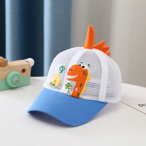 Detail of blue dinosaur baby hat featuring orange 3D spines and breathable mesh texture
