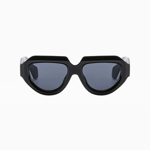 Front view detail of trendy irregular black frame sunglasses with dark grey lenses