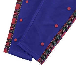 Detail of royal blue trousers showing red and green plaid side stripe with red buttons