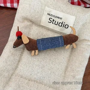Detail of creative dachshund plush hair claw clip showing textured corduroy and 10cm size