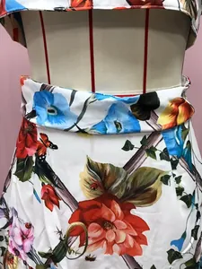 Close-up of floral print dress featuring realistic colorful flowers and butterflies