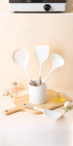 Close-up of dual-color silicone utensil set with white embossed storage container