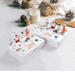 Detail of 3D Christmas gift boxes with pop-up Santa and reindeer figures for cookies