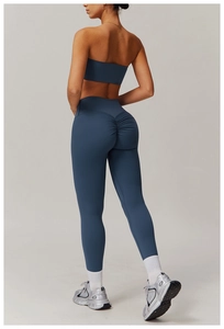 Detail view of high-waist yoga leggings with ruched butt lifting design in navy blue color