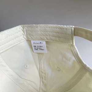 Detailed macro view of cotton baseball cap interior with 100% cotton washing label