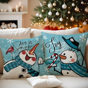 Close-up of linen Christmas pillowcases with snowmen and festive Joy typography