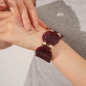 Detailed shot of retro leopard print resin bangle with a polished gold metal clasp