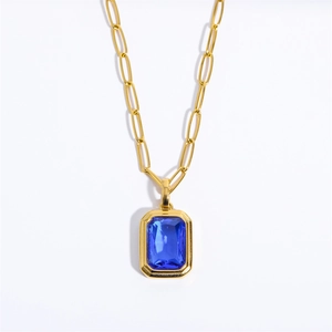 Detail of 18K gold plated paperclip chain with a blue rectangle zircon pendant