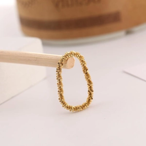 Macro shot of 18K gold plated titanium ring with sparkling textured metal finish